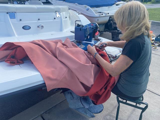 Laura sewing on boat