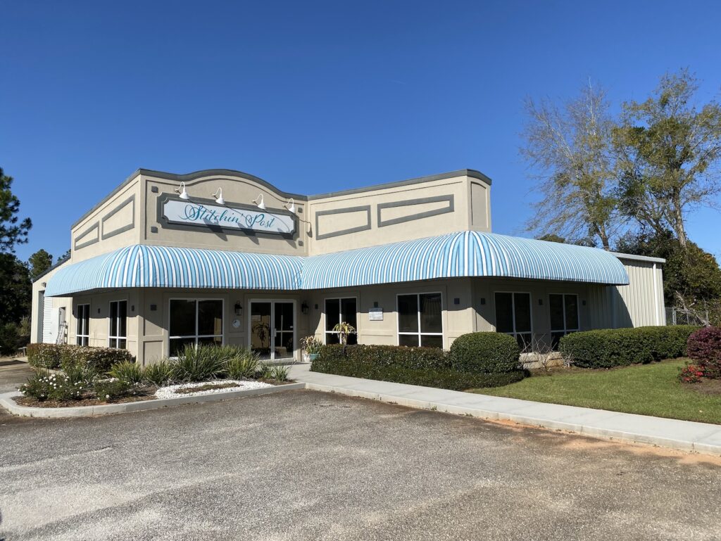 The blue-and-white striped awning matches the shop's sign perfectly.