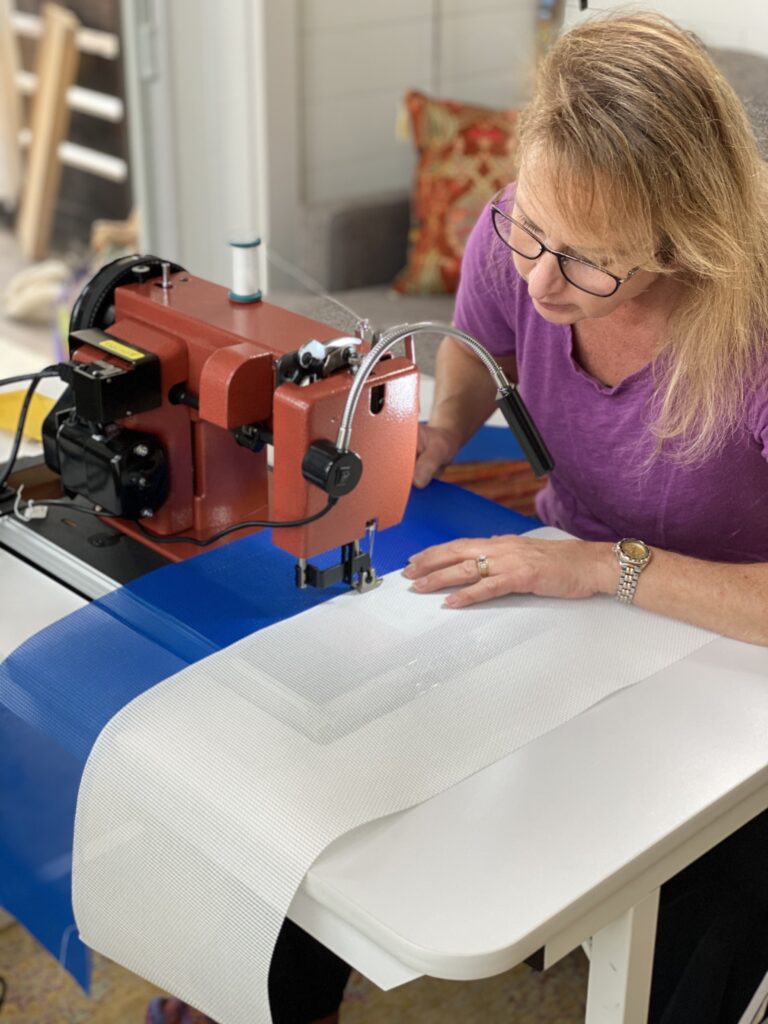 A woman using a sewing machine.